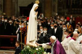 Pope Francis touches a Marian statue after consecrating the world and, in particular, Ukraine and Russia to the Immaculate Heart of Mary during a Lenten penance service in St. Peter&#039;s Basilica at the Vatican March 25, 2022.