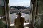 Standing in the window of the library of the Apostolic Palace overlooking an empty St. Peter&#039;s Square, Pope Francis blesses the city of Rome March 15, 2020, still under lockdown to prevent the spread of the coronavirus.