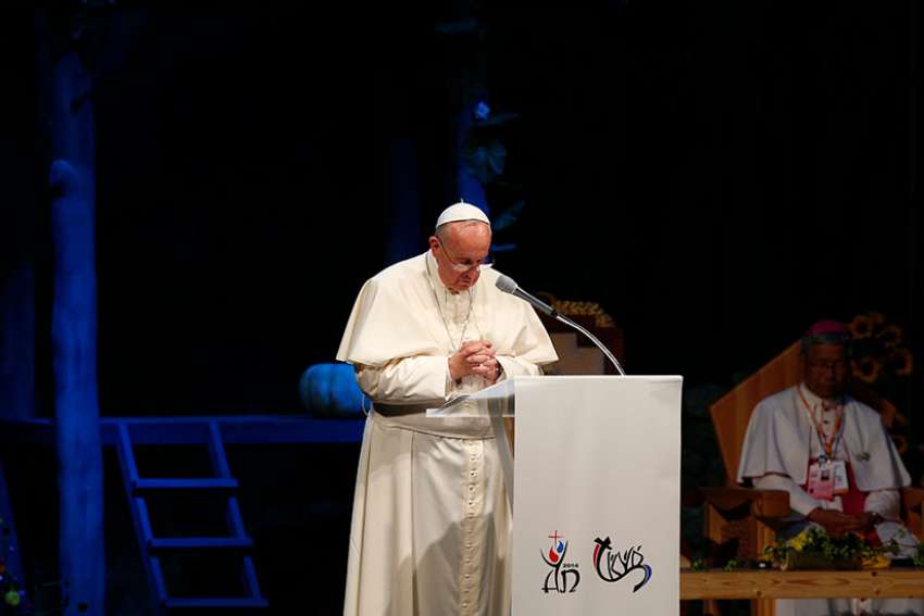 Pope Francis leads the audience in a silent prayer for Korean reunification during a meeting with Asian youth at the Sanctuary of Solmoe in South Korea Aug. 15, 2014.