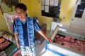 Marlon Tumenbang, owner of Matthew&#039;s Meat Shop in Tacloban, Philippines, poses for a photo Feb. 6. Tumenbang was out of business for nearly three months after his shop was flooded by Typhoon Haiyan.