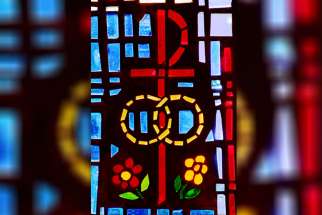 A pair of wedding bands symbolizing the sacrament of marriage is depicted in a stained-glass window at St. Isabel Church in Sanibel, Fla.