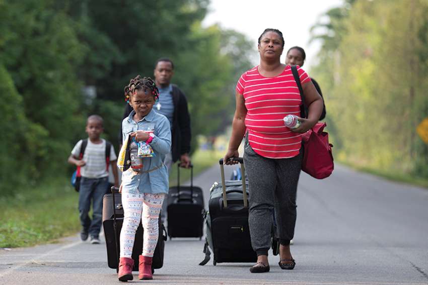 A Haitian family walks to cross the U.S.-Canada border into Quebec from New York Aug. 29. 