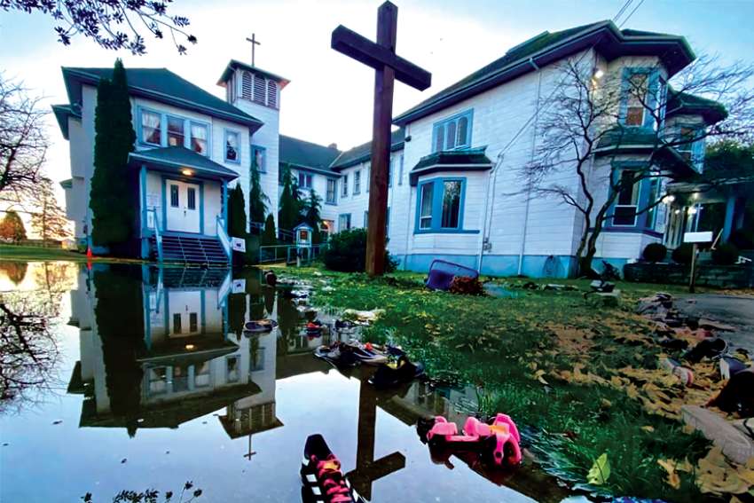 The Augustianian monastery at Sacred Heart Church in Delta, B.C., is reflected in the flood waters that have devastated the province.
