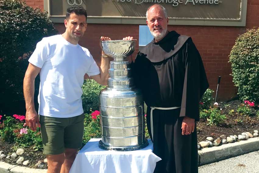 Andrew Cogliano, left winger for the Colarado Avalanche, with Fr. Mike Corcione at. St Peter’s Church in Woodbridge, Ont..