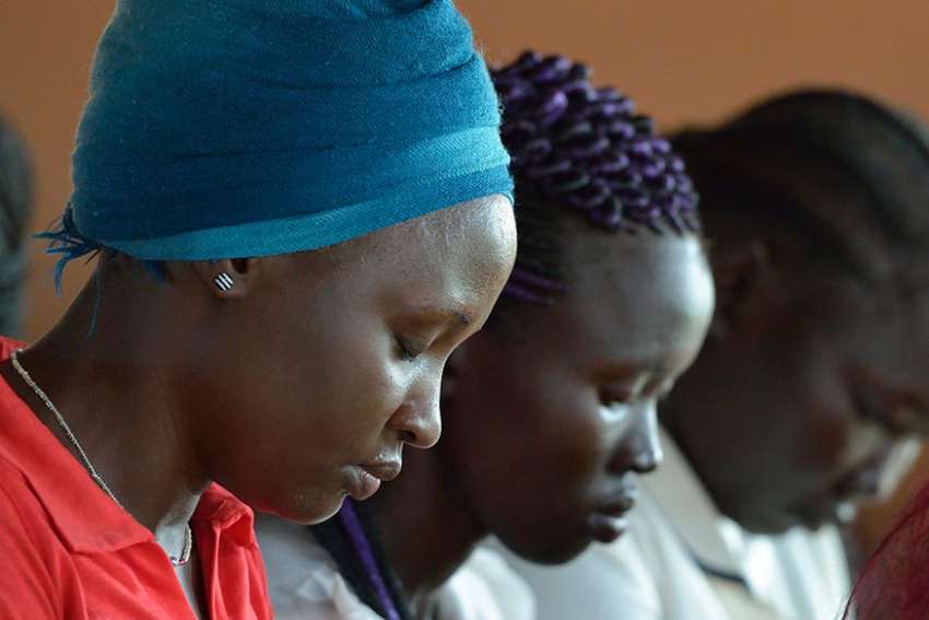 Students pray during an assembly May 1 at the Solidarity Teacher Training College in Yambio, South Sudan. 