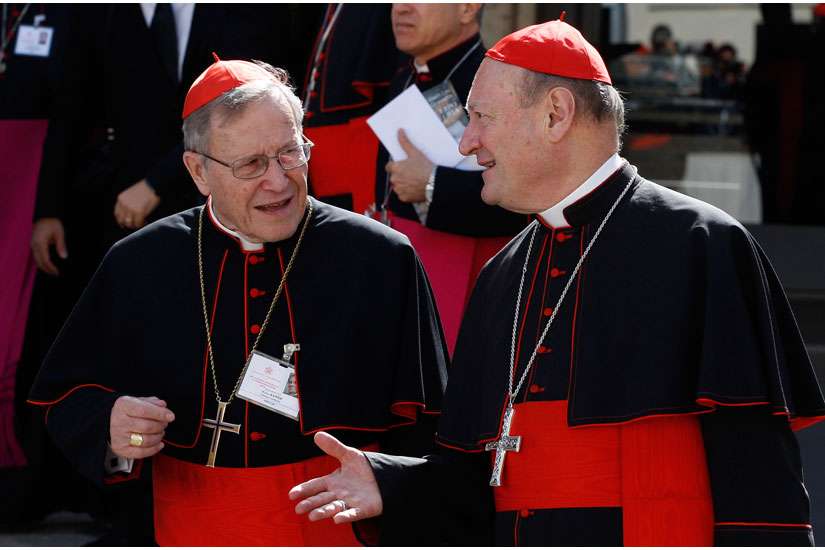 German Cardinal Walter Kasper (left), retired president of the Pontifical Council for Promoting Christian Unity, talks with Cardinal Gianfranco Ravasi, president of the Pontifical Council for Culture, as they leave the morning session of the extraordinary Synod of Bishops on the family at the Vatican Oct. 9. 