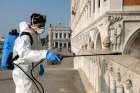 A worker sanitizes Ponte della Paglia bridge on St. Mark&#039;s Square as a measure to fight against the coronavirus in Venice, Italy, March 12, 2020.