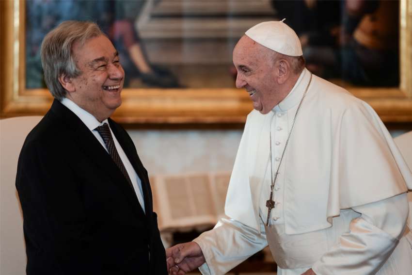 Pope Francis shares a light moment with U.N. Secretary-General Antonio Guterres during a private audience at the Vatican Dec. 20, 2019.