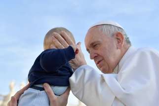 Pope Francis greets a baby as he arrives for his general audience in St. Peter&#039;s Square at the Vatican Feb. 27, 2019. 