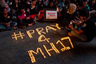 Malaysian youths gather in Petaling Jaya, Malaysia, July 18 for a candlelight vigil for passengers and crew of the Malaysian Airlines Flight MH17. Pope Francis offered prayers for the 298 passengers and crew members who died when the plane went down July 17 in eastern Ukraine.