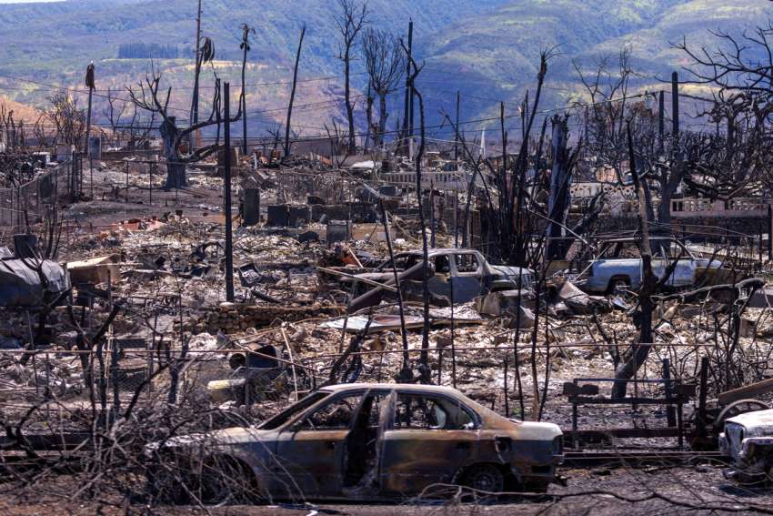 The shells of burned cars are pictured amid the ruins of homes in the ravaged town of Lahaina, Hawaii, on the island of Maui Aug.15, 2023. Honolulu Bishop Larry Silva is urging the faithful of the diocese to &quot;come together and provide unwavering support&quot; to those who have lost everything in the Maui wildfires that destroyed Lahaina and damaged other communities Aug. 8 and 9.