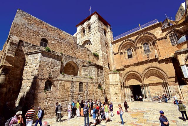 Pilgrims stand outside the Church of the Holy Sepulchre in Jerusalem’s Old City. Christian groups say police action keeps pilgrims from accessing the site during Holy Week and Easter.