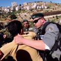 An Israeli border officer grabs a Palestinian man as police attempt to stop a non-violent protest by Christians and Muslims in the West Bank village of Beit Jalla March 7. The demonstration took place as Israel was clearing olive trees, a source of income for Palestinians, to make way for an extension of the Israeli separation barrier.