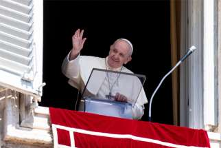 Pope Francis greets the crowd as he leads the Angelus from the window of his studio overlooking St. Peter&#039;s Square at the Vatican Aug. 23, 2020. The pope prayed for people persecuted for their faith, remembered the victims of the 2010 San Fernando massacre in Mexico and prayed for the victims of COVID-19.