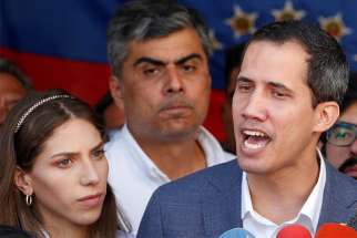 Venezuelan opposition leader Juan Guaido, alongside his wife, Fabiana Rosales, speaks to the media after attending Mass in Caracas Feb. 10, 2019. Although it has publicly taken a neutral stance in the current political crisis in Venezuela, the Vatican has expressed its support for new elections in the country within the year, said a member of a delegation representing Guaido. 