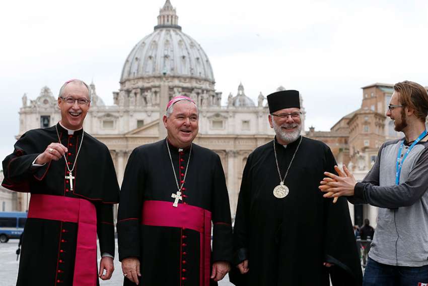 Seamus McKelvey of Winnipeg, Manitoba, crashes a group photo with Canadian bishops in front of St. Peter&#039;s Basilica March 27. From left are Archbishops Richard Smith of Edmonton, Alberta; Richard Gagnon of Winnipeg, Manitoba; and Bishop Kenneth Nowakowski of the Ukrainian Diocese of New Westminster, British Columbia. The bishops were making their &quot;ad limina&quot; visits to the Vatican to report on the status of their dioceses.