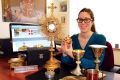 Andrea D’Angelo, processing archivist with the Archives of the Roman Catholic Archdiocese of Toronto, with some of the items available to parishes through the new SOX — Sacred Objects Exchange.