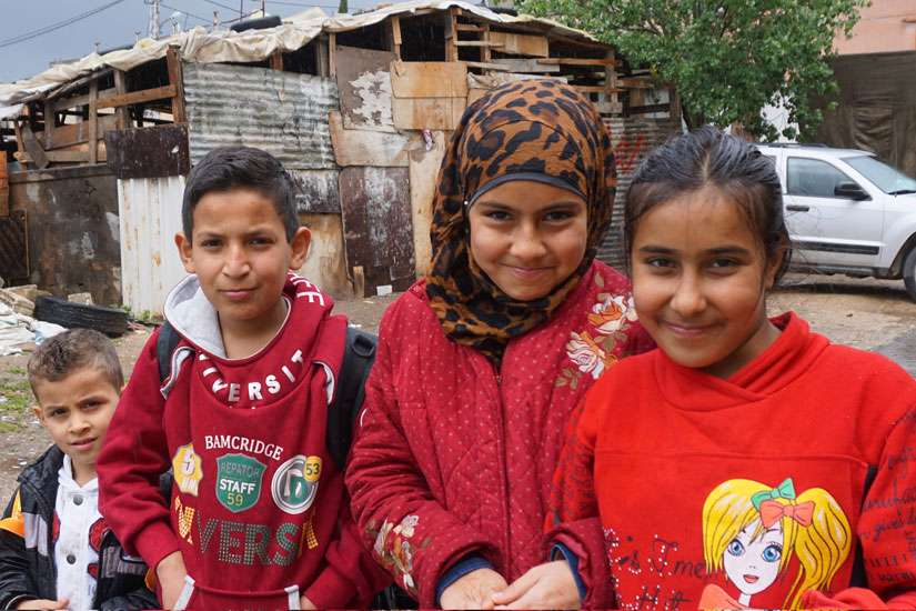 Syrian refugee children stand outside their school in Zahle, Lebanon, in the country&#039;s Bekaa Valley April 12. The international Catholic charity Caritas has been instrumental in helping Syrian refugees attend Lebanese public schools to continue their education.