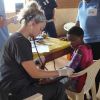 Shayla Roberts looks after a Tanzanian child on the recent Chalice medical mission. 