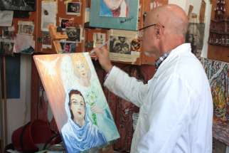  Prison inmate Marcello D&#039;Agata paints an image of the Annunciation for use as one of the Vatican&#039;s 2018 Christmas stamps, at the Opera prison in Milan in this undated photo. 