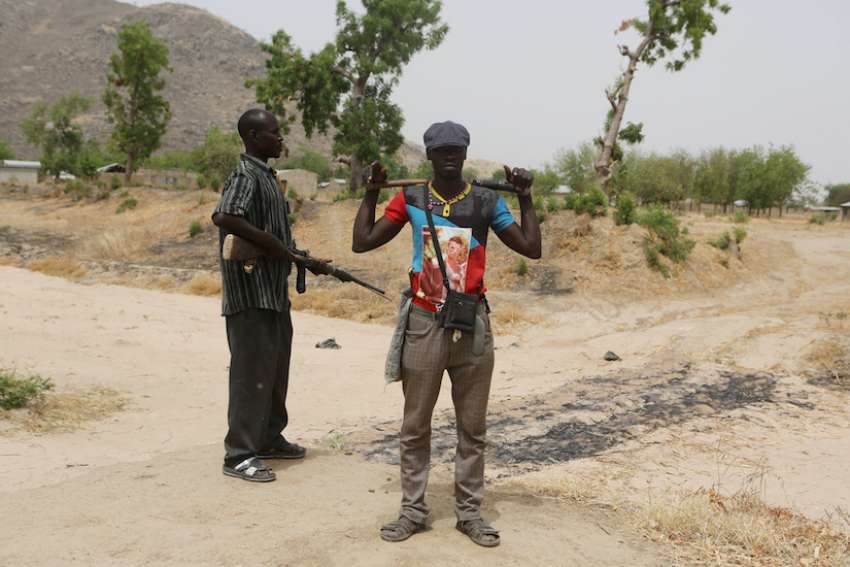 Members of a civilian vigilante group stand guard at the border with Nigeria in Kerawa, Cameroon, March 16, 2016. The latest threat to Christians in Nigeria are the Fulani Herdsmen Terrorists says Aid to the Church in Need&#039;s Maria Lozano.