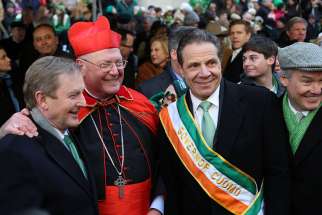 New York Cardinal Timothy M. Dolan, center, poses with Irish Prime Minister Enda Kenny and New York Gov. Andrew Cuomo during the St. Patrick&#039;s Day Parade March 17 in New York City. 
