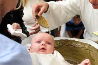 A baby is seen during her baptism. France&#039;s Catholic bishops criticized legislation to allow medically assisted procreation for single mothers and lesbian couples and urged citizens to help block its enactment.