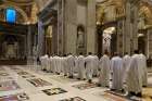 Priests in St. Peter&#039;s Basilica process to the altar where St. John Paul II is buried at the Vatican in this Feb. 13, 2020, photo. Dozens of priests concelebrate an early morning Mass at the tomb every Thursday.