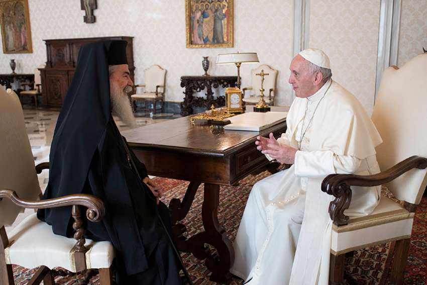 Pope Francis talks with Greek Orthodox Patriarch Theophilos III of Jerusalem during a private audience at the Vatican Oct. 23. 