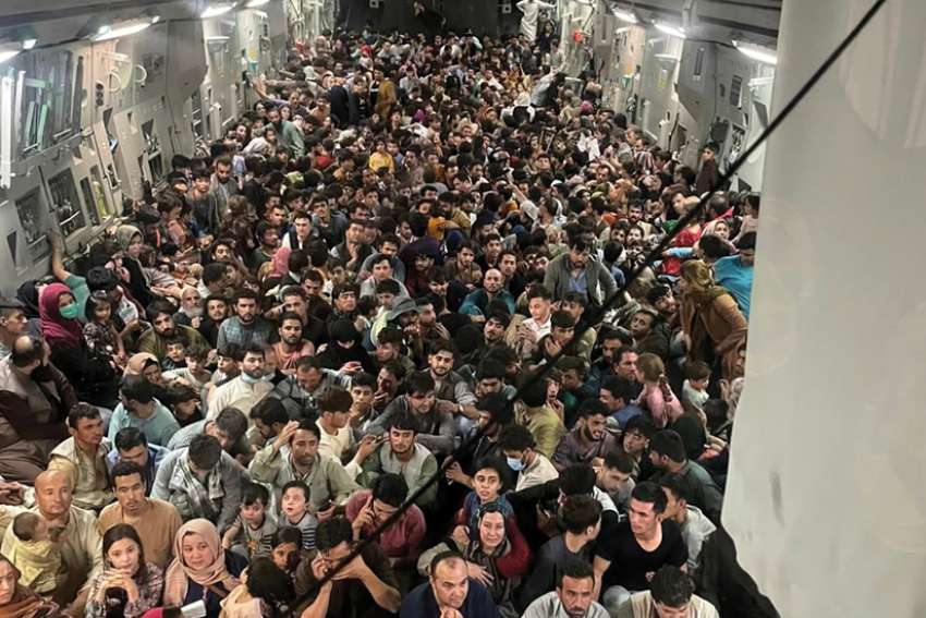 Evacuees crowd the interior of a U.S. Air Force C-17 Globemaster III transport aircraft carrying nearly 700 Afghans from Kabul to Qatar Aug. 15.
