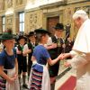 Children dressed in the traditional Bavarian garb greet Pope Benedict XVI during the pontiff&#039;s 85th birthday celebrations in the Clementine Hall at the Vatican April 16.