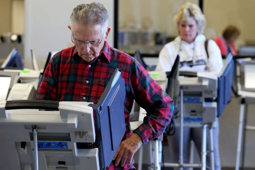 Voters cast ballots in Cleveland as early absentee voting began Oct. 12 ahead of the Nov. 8 U.S. presidential election.