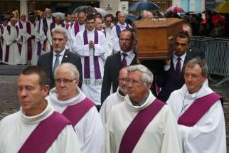 Pallbearers carry the coffin of Father Jacques Hamel Aug. 2 outside the cathedral in Rouen, France. Father Hamel was killed July 26 in an attack on a church at Saint-Etienne-du-Rouvray near Rouen; the attack was carried out by assailants linked to the Islamic State.