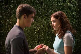 Brenton Thwaites and Odeya Rush star in a scene from the movie &quot;The Giver.&quot; Catholic News Service classification, A-II -- adults and adolescents. Motion Picture Association of America rating, PG-13 -- parents strongly cautioned. Some material may be inap propriate for children under 13.