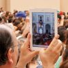 A pilgrim uses an iPad to photograph Pope Benedict XVI as he leads the Angelus prayer in Castel Gandolfo, Italy, last August.