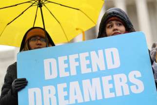  Demonstrators in support of DACA hold signs outside the U.S. Supreme Court in Washington Nov. 12, 2019.