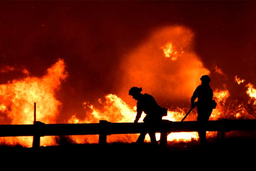 Firefighters battle a wind-driven wildfire Oct. 25, 2019, in Canyon Country near Los Angeles. The Archdiocese of Los Angeles is providing support to the communities affected by the fires through Catholic Charities of Los Angeles and local parishes and schools.