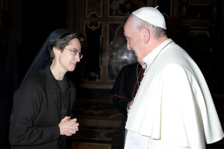 Pope Francis greets Sister Raffaella Petrini, an Italian member of the U.S.-based Franciscan Sisters of the Eucharist, at the Vatican Dec. 3, 2015. The pope has named Sister Petrini to be secretary-general of the office governing Vatican City State.