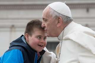 Pope Francis kisses Peter Lombardi, 12, of Columbus, Ohio, after the boy rode in the popemobile during his general audience in St. Peter&#039;s Square at the Vatican March 28. Receiving a kiss from the Pope was a wish come true for Peter, who has Down syndrome and has survived leukemia.