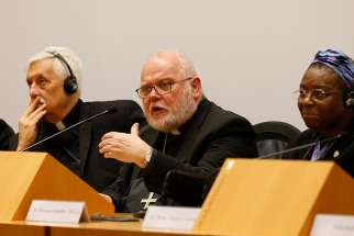 Cardinal Reinhard Marx of Munich speaks at a briefing on the third day of the meeting on the protection of minors in the church at the Vatican Feb. 23, 2019. Also pictured are Father Arturo Sosa Abascal, superior general of the Society of Jesus, and Nigerian Sister Veronica Openibo, congregational leader of the Society of the Holy Child Jesus. 