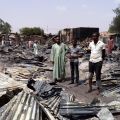 People gather around the ruins of the burned Bama Market in Maiduguri, Nigeria, April 29, after it was destroyed by gunmen. Nigerian bishops have expressed hope that government actions in the country&#039;s northeast will result in a more normal, less violent situation for people.
