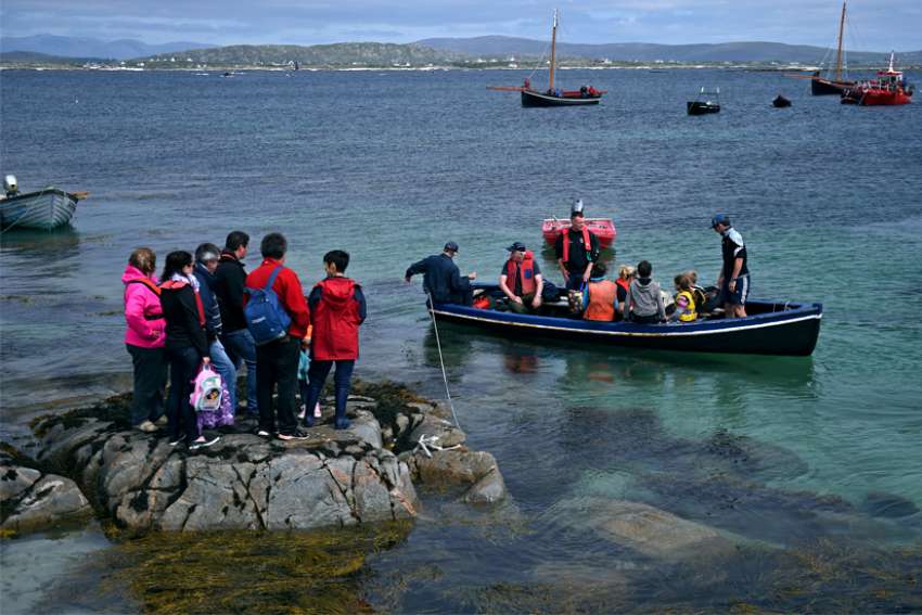 Seafarers and other worshippers from Carna, Ireland, are seen in 2016 during the annual pilgrimage to MacDara&#039;s Island to celebrate Mass in honor of St. MacDara, patron saint of fishermen. Pope Francis has granted Apostleship of the Sea chaplains broader permission for granting absolution to those working far from home.
