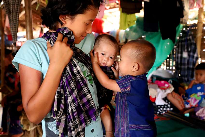 A displaced ethnic Kachin family is seen in early May at a temporary camp on the grounds of a Catholic church in Myitkyina, Myanmar. Myanmar&#039;s military still is persecuting ethnic Kachin, the predominant Christian group in a conflict-torn part of the country, as well as Rohingya Muslims, Cardinal Charles Maung Bo of Yangon said.