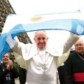 Pope Francis holds up Argentina’s flag as he greets a crowd of World Youth Day pilgrims outside the cathedral in Rio de Janeiro July 25.