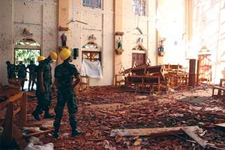 Officials look over the damaged St. Sebastian Catholic Church in Negombo, Sri Lanka, in the aftermath of the April 21 bombings across the nation.