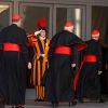 A Swiss Guard salutes as U.S. Cardinals Roger M. Mahony, retired archbishop of Los Angeles, Edward M. Egan, retired archbishop of New York, and Donald W. Wuerl of Washington arrive for the first general congregation meeting in the synod hall at the Vatic an March 4.
