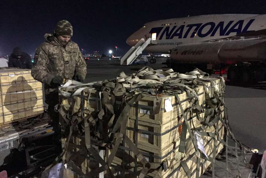 Military aid, delivered as part of U.S. security assistance to Ukraine, is unloaded from a plane at the Boryspil International Airport outside Kyiv Feb. 13, 2022.