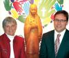 Blessed Kateri Tekakwitha Elementary School principal Paul Gautreau (right) in front of a wood carving of the school’s namesake with former teacher Line Douglas who will speak to students during the school’s Oct. 22 canonization celebration.