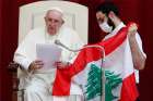 Pope Francis and Maronite Father Georges Briedi hold a Lebanese flag as they pray for the country -- following an explosion in Beirut -- during the the pope&#039;s weekly general audience at the Vatican Sept. 2, 2020.