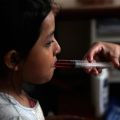 A nurse uses a syringe to give liquid medicine to a young HIV patient at San Jose Hospice in Sacatepequez, Guatemala, in 2011. Pope Benedict XVI, speaking before World AIDS Day Dec. 1, said his thoughts and prayers were with &quot;the great number of children who contract the virus every year from their own mothers, despite the fact there are therapies for preventing it.&quot;